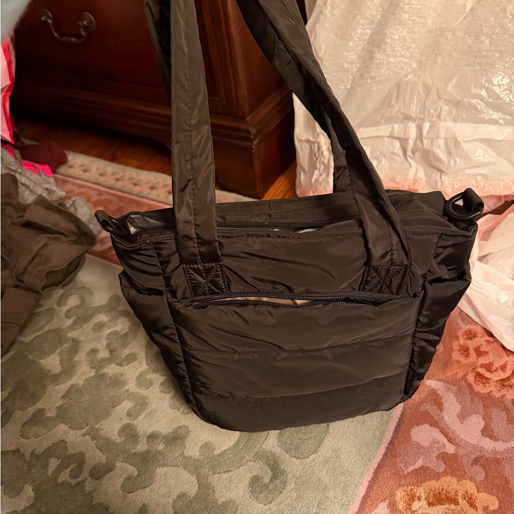 Black lunch bag with cupholder pockets, and zip pockets